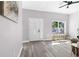 Bright foyer with hardwood floors, white trim, and a decorative front door, showcasing the entryway's elegance at 1738 Palm Rd, Ormond Beach, FL 32174