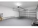 Garage with white walls, painted gray floor, and garage door at 1738 Palm Rd, Ormond Beach, FL 32174
