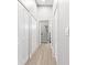 Hallway view leading to a bathroom with a marble shower, and closet doors at 1738 Palm Rd, Ormond Beach, FL 32174