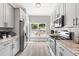 Contemporary kitchen with stainless appliances, sleek cabinetry, and a sunlit window at 1738 Palm Rd, Ormond Beach, FL 32174