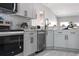 Modern kitchen featuring gray cabinets, subway tile backsplash, and stainless steel appliances at 1738 Palm Rd, Ormond Beach, FL 32174