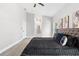 Bedroom showcasing a dark bed, modern art, and an open hallway leading to the bathroom at 1738 Palm Rd, Ormond Beach, FL 32174