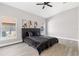Spacious bedroom featuring a dark upholstered headboard, a ceiling fan, and bright windows at 1738 Palm Rd, Ormond Beach, FL 32174