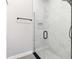 Close-up of a modern shower with black hardware and sleek marble tile at 1738 Palm Rd, Ormond Beach, FL 32174