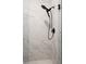 Elegant shower with marble-patterned tile and sleek black shower head at 1738 Palm Rd, Ormond Beach, FL 32174