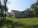 Expansive backyard featuring well-maintained lawn, lush trees, and a screened-in patio at 1870 Pepper Tree Ln, Deland, FL 32720