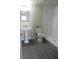 Bathroom featuring a walk-in shower, pedestal sink, and toilet at 1870 Pepper Tree Ln, Deland, FL 32720