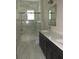 Modern bathroom features dual sinks, quartz countertops, and a glass-enclosed shower and tub at 1870 Pepper Tree Ln, Deland, FL 32720