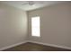 Bedroom features wood-look vinyl flooring and a window letting in natural light at 1870 Pepper Tree Ln, Deland, FL 32720