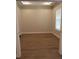 Bright bedroom featuring wood-look flooring and a window with blinds allowing natural light at 1870 Pepper Tree Ln, Deland, FL 32720