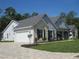 Beautiful single-story home features a stone facade and well-manicured landscaping along a lovely paved driveway at 1870 Pepper Tree Ln, Deland, FL 32720