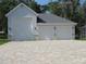 View of the spacious three-car garage featuring brick pavers on the driveway at 1870 Pepper Tree Ln, Deland, FL 32720
