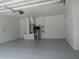 Attached two-car garage with epoxy floors, utility hookups, and water heater at 1870 Pepper Tree Ln, Deland, FL 32720