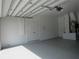 Attached two car garage with epoxy floors, white walls and storage at 1870 Pepper Tree Ln, Deland, FL 32720