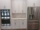 The kitchen features stainless steel appliances, custom cabinets and a marble backsplash giving a high-end feel at 1870 Pepper Tree Ln, Deland, FL 32720
