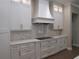This kitchen boasts stainless appliances, white cabinets, a cooktop, and bright white countertops at 1870 Pepper Tree Ln, Deland, FL 32720