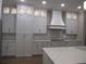 A bright, modern kitchen boasts custom white cabinets, modern appliances, and great storage space at 1870 Pepper Tree Ln, Deland, FL 32720