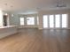 A spacious living room with neutral tones, lots of light, and wood floors for a bright and airy feel at 1870 Pepper Tree Ln, Deland, FL 32720