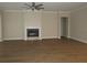 This spacious living room has a fireplace, wood floors, and neutral walls perfect for gatherings at 1870 Pepper Tree Ln, Deland, FL 32720