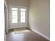 Bright office space with wood-style flooring and double doors leading to the outside at 1870 Pepper Tree Ln, Deland, FL 32720