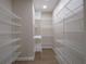 Spacious walk-in pantry featuring metal shelving and ample storage space at 1870 Pepper Tree Ln, Deland, FL 32720