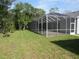 Covered patio featuring ceiling fans, stone flooring, and backyard views, accessible through double doors at 1870 Pepper Tree Ln, Deland, FL 32720
