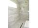 A luxurious shower with dual shower heads and marble-style tiling at 1870 Pepper Tree Ln, Deland, FL 32720