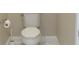 A white toilet with chrome fixtures is shown in a small, neutral-colored bathroom at 1870 Pepper Tree Ln, Deland, FL 32720