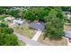 Aerial view of the home with lush trees and a long driveway in a quiet neighborhood setting at 20 Monroe Ave, Debary, FL 32713