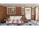 Charming back porch with brick walls, a comfortable sofa, and access to the outdoors at 20 Monroe Ave, Debary, FL 32713