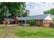 Well-maintained brick home with a spacious backyard, screened-in patio, and lush landscaping at 20 Monroe Ave, Debary, FL 32713