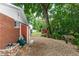 Spacious backyard with gravel, a storage shed, and mature trees, creating a serene outdoor environment at 20 Monroe Ave, Debary, FL 32713