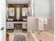 Stylish bathroom featuring double sinks, decorative wood wall, soaking tub, and tiled accents at 20 Monroe Ave, Debary, FL 32713