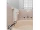 A serene bathroom with a relaxing soaking tub and a calming pink tile surround at 20 Monroe Ave, Debary, FL 32713