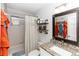 Well-lit bathroom featuring a granite vanity, shower-tub combination and a framed mirror at 20 Monroe Ave, Debary, FL 32713