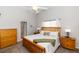 Bright bedroom features a wooden bed frame, neutral walls and a view to the bathroom at 20 Monroe Ave, Debary, FL 32713