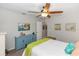 Bright bedroom featuring a vibrant accent painting and decorative blue cabinet at 20 Monroe Ave, Debary, FL 32713