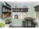 Cozy breakfast nook with a round table and bar stools, next to a window, surrounded by decorative shelves at 20 Monroe Ave, Debary, FL 32713