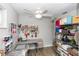 Well-organized craft room with shelving, worktable, storage and ceiling fan at 20 Monroe Ave, Debary, FL 32713