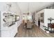 Dining area with stylish woven chairs, modern light fixture, and wood-look floors at 20 Monroe Ave, Debary, FL 32713