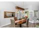 Cozy dining room features a wood table, woven chairs, and modern light fixture at 20 Monroe Ave, Debary, FL 32713