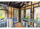 Gazebo interior with rustic furniture, a potting station, and views of the lush outdoor surroundings at 20 Monroe Ave, Debary, FL 32713