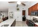 Spacious kitchen features stainless steel appliances, granite countertops, and a decorative ceiling fan at 20 Monroe Ave, Debary, FL 32713