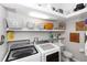 Well-organized laundry room equipped with a washer, dryer, sink, and ample storage shelves at 20 Monroe Ave, Debary, FL 32713