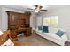 Cozy living room with built-in desk, ceiling fan and comfortable sofa at 20 Monroe Ave, Debary, FL 32713