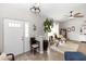 Bright living room with wood-look floors, neutral walls, and a decorative ceiling fan at 20 Monroe Ave, Debary, FL 32713