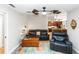 Inviting living room featuring a comfortable black leather sofa and seamlessly connected to the kitchen at 20 Monroe Ave, Debary, FL 32713