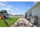 Backyard features a fire pit, grill, play structure, and green lawn at 2000 White Pelican Ter, Sanford, FL 32771
