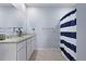 Bathroom featuring double vanity sinks with granite countertops, and shower with striped curtain at 2000 White Pelican Ter, Sanford, FL 32771