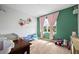 Green bedroom with carpet, pink curtains, and plenty of natural light at 2000 White Pelican Ter, Sanford, FL 32771